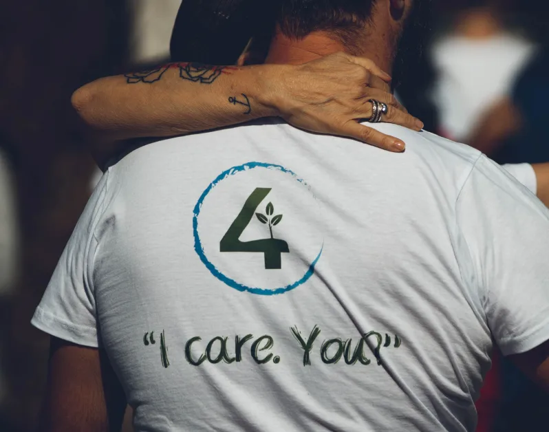 We4all volunteer wearing an «I care. You?» t-shirt
