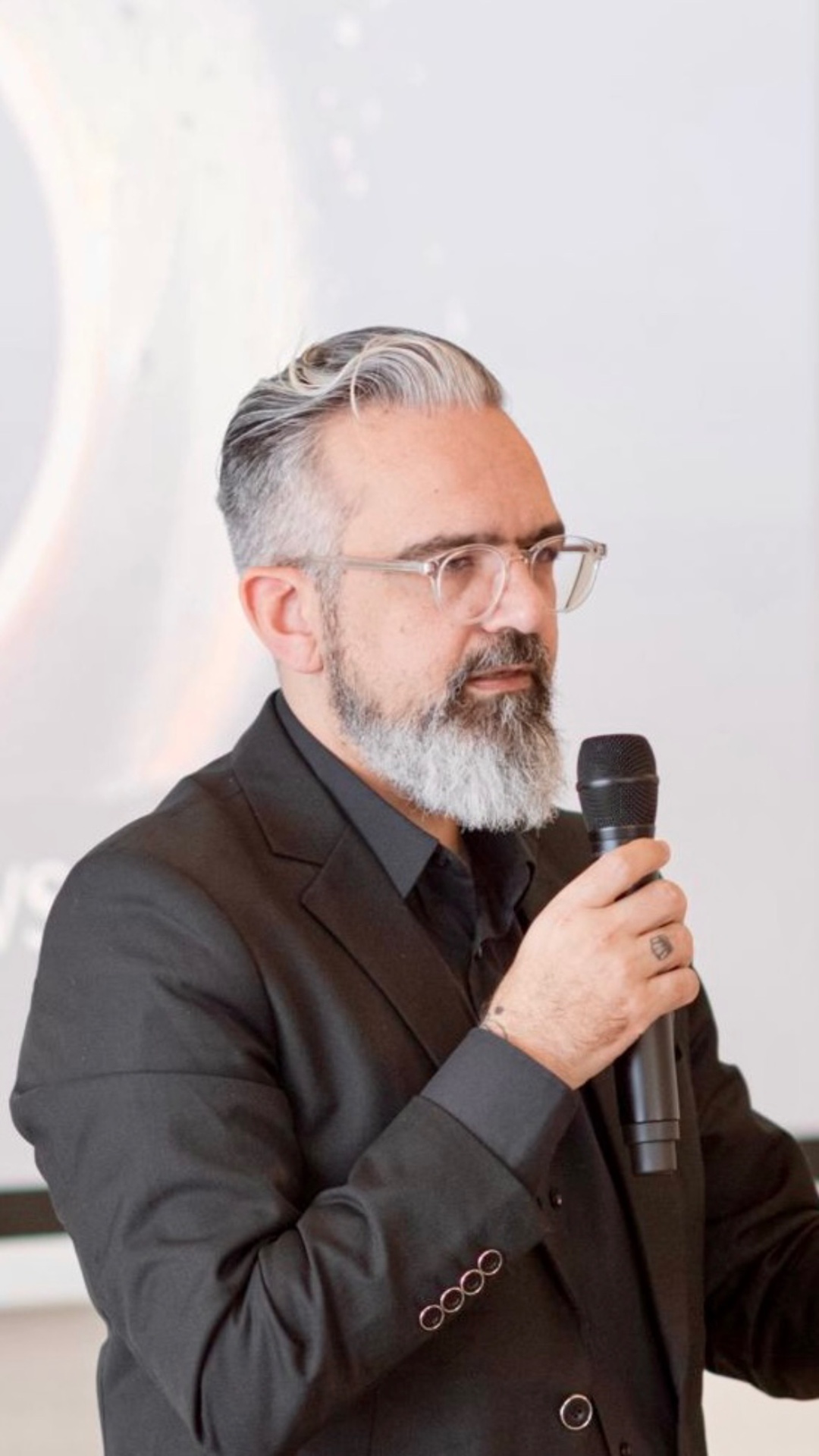Theodore Georgedakis speaking with microphone