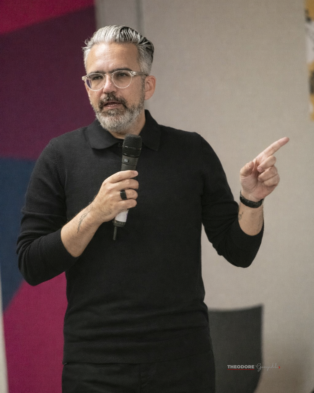 Theodore Georgedakis speaking, pointing while presenting